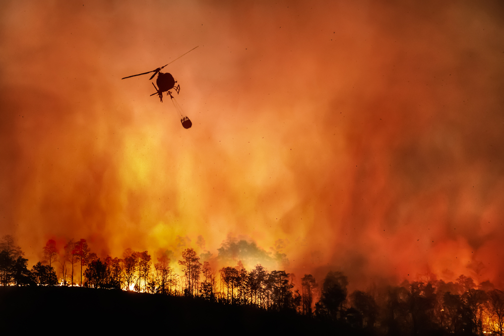 Emergency management helicopter extinguishing wildfires in California