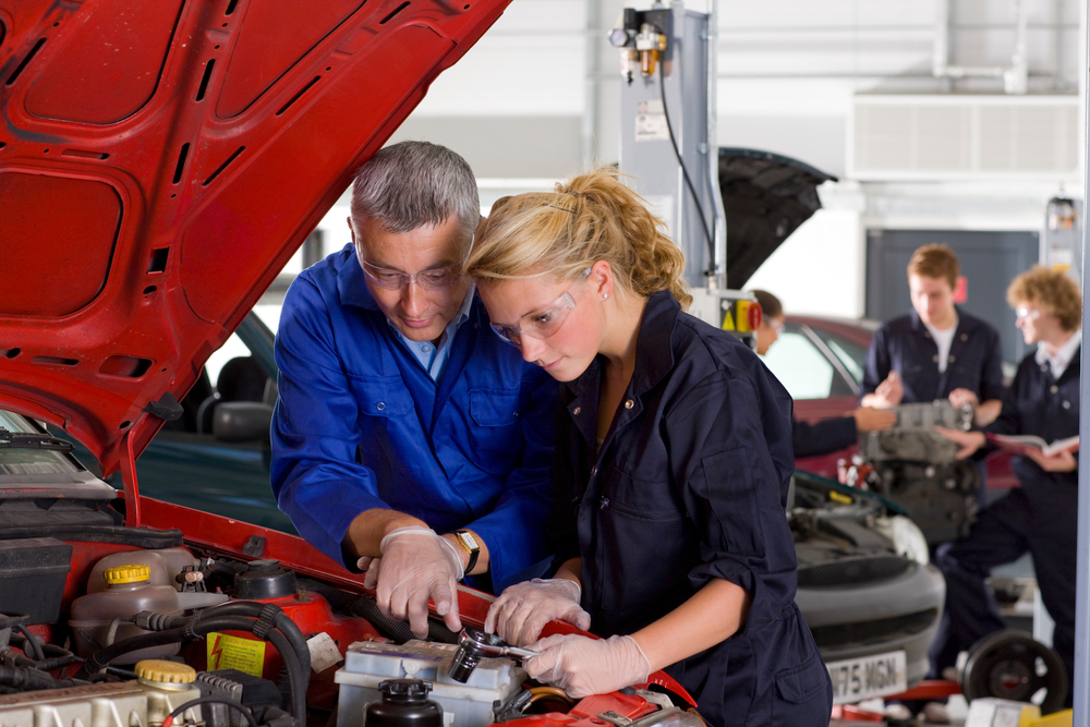 trade school student learning from professor, car mechanic